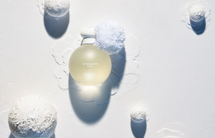 white moss & snowdrop 100ml cologne in limited edition frosted glass design and snowball shape. Surrounded by white snowballs 
